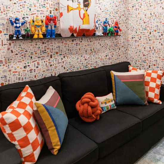 combination of wallpaper and sofa cushions in an apartment interior